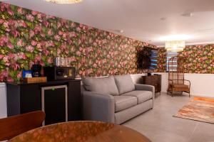 ein Wohnzimmer mit einem Sofa und einer Blumenwand in der Unterkunft Whitelaw Hotel in Miami Beach