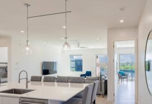 a kitchen and living room with white walls at Five Palms PENTHOUSE in George Town