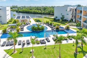 an aerial view of a resort with a pool and palm trees at Five Palms PENTHOUSE in George Town