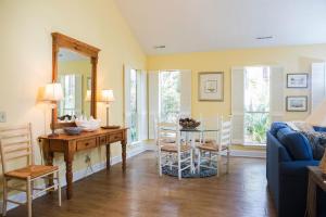 a dining room with a table and a blue couch at South Beach Lane 47 in Hilton Head Island