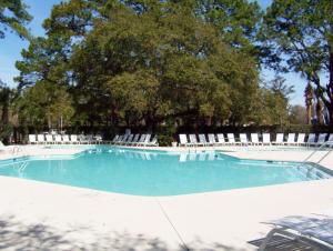 a large swimming pool with chairs and trees at South Beach Lane 47 in Hilton Head Island
