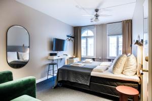 a bedroom with a large bed and a mirror at Kings Square apartments by Daniel&Jacob's in Copenhagen