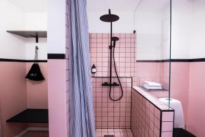 a bathroom with pink tile and a shower at Kings Square apartments by Daniel&Jacob's in Copenhagen