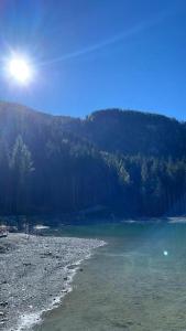 a body of water with a mountain in the background at Ferienwohnung Dalmatiner in Nauders