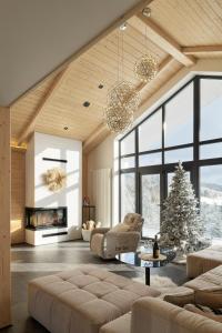 a living room with a christmas tree and a couch at be be Chalet - premium jacuzi & private pool in Bukovel