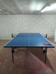 a blue ping pong table in a room at Belle maison proche de la ville et du lac in Belcaire