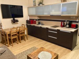 a kitchen with a table and a counter top at Apartament Comfort Kahlberg in Krynica Morska