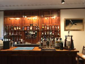 a bar with a lot of bottles of alcohol at Dalrachney Lodge in Carrbridge