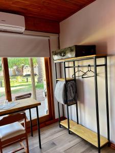 a room with a bunk bed and a table and a window at La Posada del Minero in Minas de Corrales