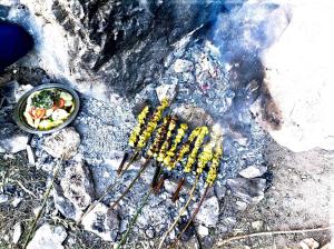 a grill with a bowl of food on top of rocks at Taghia Gîte du Grimpeur in Taghia