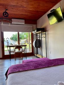 a bedroom with a bed and a desk with a tv at La Posada del Minero in Minas de Corrales