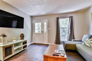 a living room with a couch and a tv at 6 miles to downtown Asheville. Sleeps 5. in Asheville