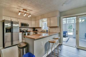 a kitchen with a refrigerator and a counter with stools at 6 miles to downtown Asheville. Sleeps 5. in Asheville
