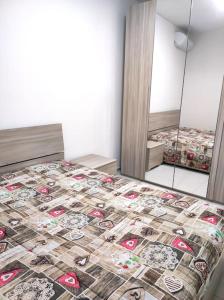 a bedroom with a bed with a quilt on it at Central rooms in Agira