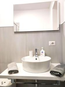 a bathroom with a white sink and a mirror at Central rooms in Agira +5 photos