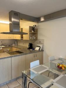 a kitchen with a glass table and a counter top at Amazing lakeview flat Horn in Horn