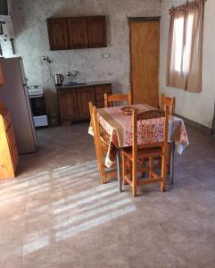 a kitchen with a table and chairs and a kitchen with a refrigerator at L' AMORE DELLA NONNA in San Rafael