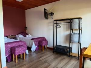 a hotel room with two beds and a mirror at La Posada del Minero in Minas de Corrales