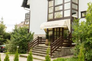 a house with a entrance to a building at Protekal Wellness & SPA in Zlatibor
