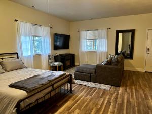a bedroom with a bed and a chair and a mirror at Sonia's Guest Suite in Montesano-Gateway to Olympic National Park in Montesano
