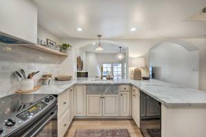 a kitchen with white cabinets and a large counter top at Scottsdale Condo with Pool Access, Near Old Town! in Scottsdale