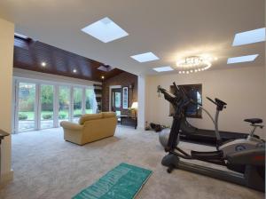 a room with a gym with a treadmill and a couch at Solway in Chester