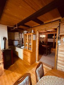- une cuisine et une salle à manger dans une cabane en rondins dans l'établissement Chalet PJagodic, à Cerklje na Gorenjskem
