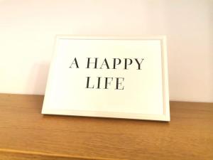 a picture of a happy life on a wooden table at Lovely 1 Bed Flat in Trendy Peckham in London
