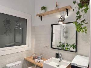 a bathroom with a sink and a mirror at Charming appartement in the heart of Barcelona in Barcelona