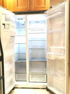 an empty refrigerator with its door open in a kitchen at Lovely 1 Bed Flat in Trendy Peckham in London