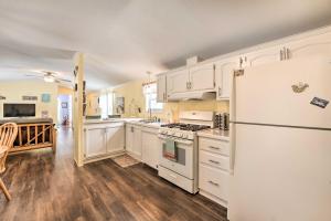 een keuken met witte kasten en een witte koelkast bij Charming South Haven Home - Great Location! in South Haven
