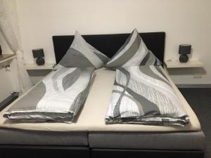 a bed with three pillows on top of it at Emotion zentrumsnah für bis zu 6 Personen in Winterberg