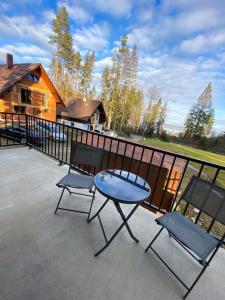 a patio with a table and chairs and a house at Chata TRI GROŠE 1 in Námestovo +23 photos