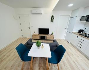 a living room with a couch and a table at VIP -Apartamentos Birdie- in Albacete