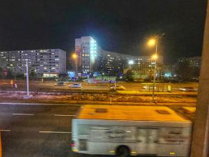 a bus driving down a city street at night at A Towns Charm in Sarajevo