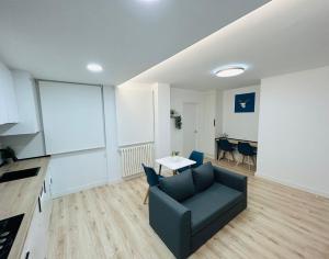 a living room with a couch and a table at VIP -Apartamentos Birdie- in Albacete