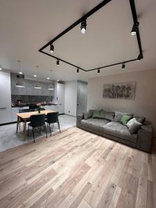 a living room with a couch and a table at ВІП стилізовані у Львові з просторою вітальнею, на вулиці Під Голоском 15 Б in Lviv +22 photos