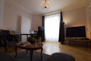 a living room with a television and a coffee table at 3-room separate unit in Sceaux (80 sq.m/860 sq.ft) in Sceaux