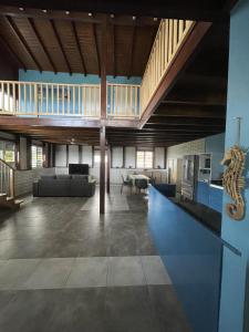 a large living room with a couch and a table at O'Chalet des îles in Capesterre-Belle-Eau