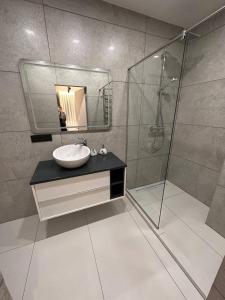 a bathroom with a sink and a shower at Інстаграмна стильні апартаменти на вулиці Під Голоском 15б in Lviv