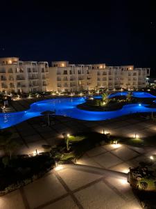 a large building with blue lights in a parking lot at Sunny beach sharm el sheikh in Sharm El Sheikh