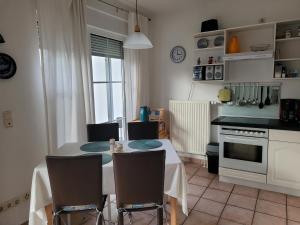a kitchen with a table and chairs in a kitchen at Inselzauber in Breege +18 photos