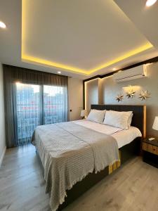 a bedroom with a large bed and a window at ONLY ONE Suites & Residences in Antalya +85 photos