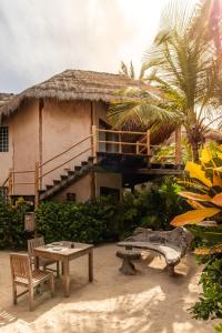 a house with a table and chairs in front of it at Encantada Tulum in Tulum