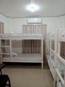 a room with two bunk beds in a room at Meghan’s Homestay in General Luna