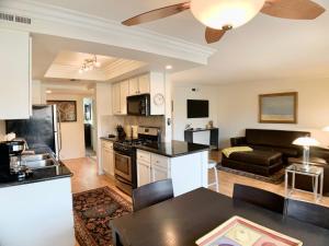 a kitchen and living room with a table and a couch at Sunrise Springs 1-Bedroom with Balcony & Pool in Palm Springs