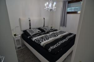 a bed with zebra pillows on it in a room at BFE Schwarzwaldnest in Baiersbronn