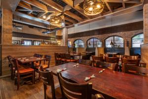 a dining room with wooden tables and chairs at Best Western Premier Bridgewood Hotel Resort in Neenah