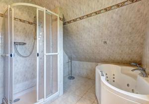 a bathroom with a bath tub and a shower at Ferienhaus Clara in Benz +19 photos