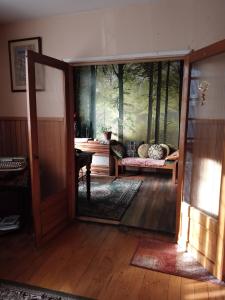 an open door to a living room with a couch at Hostal Patrimonial Angelmó in Puerto Montt